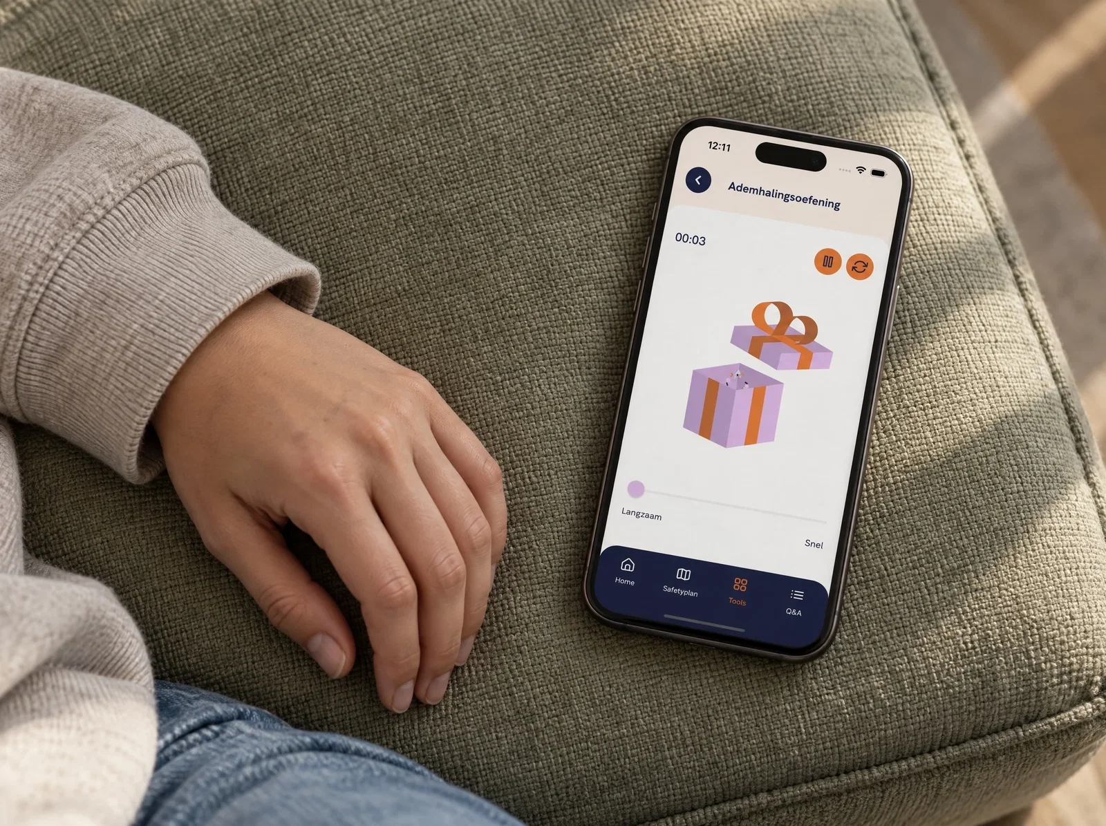 The Spark* breathing exercise on a smartphone beside a relaxed hand.